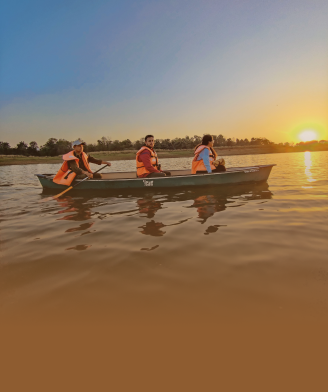 Guests boating at sunset on the Denwa River