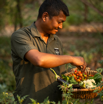 Chef Krishna holding produce from the garden
